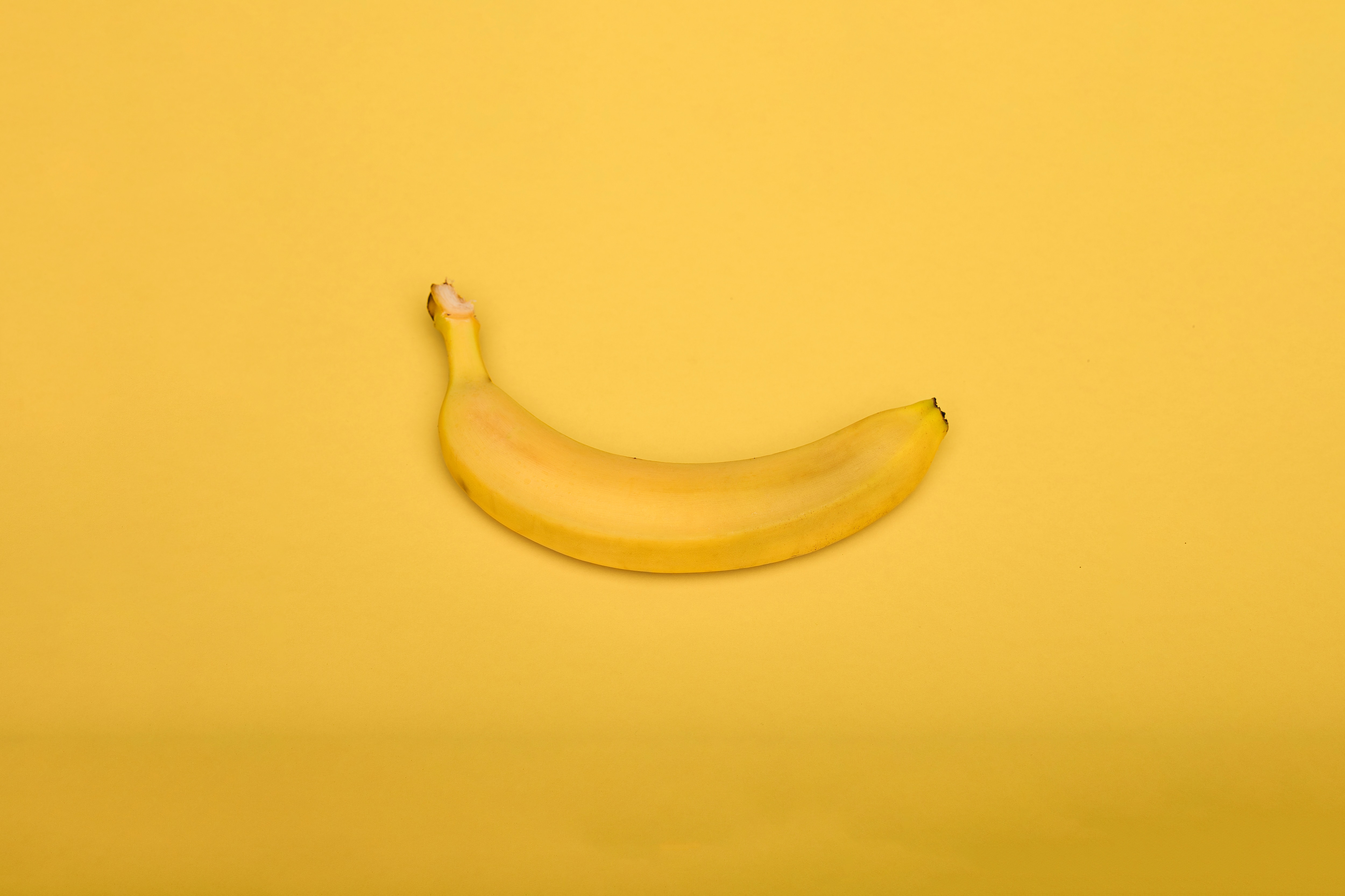 yellow banana on yellow surface